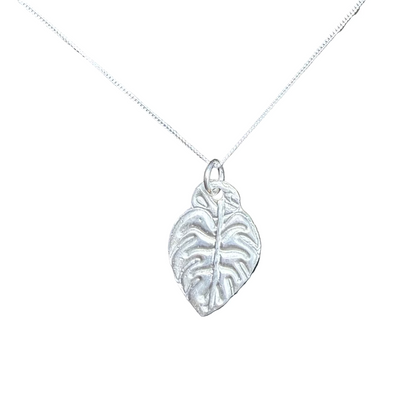 Silver leaf pendant on a chain against a white background