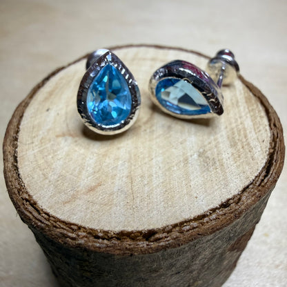ocean-topaz-blue-drop-earrings-on-log