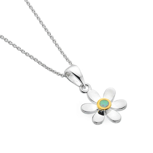 Silver flower-shaped pendant with a green gemstone on a white background
