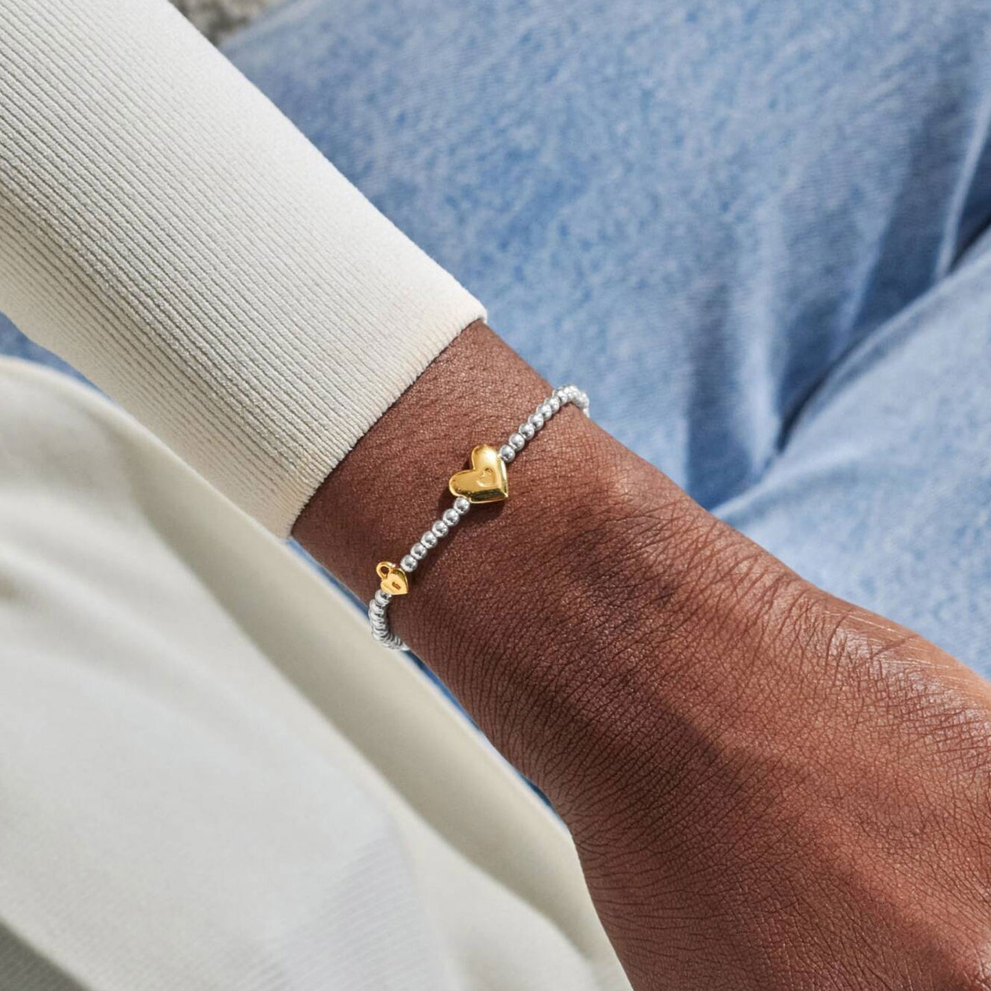 heart charm bracelet on wrist