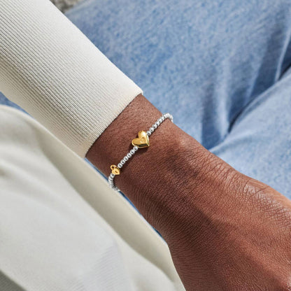heart charm bracelet on wrist