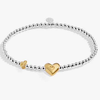 beaded bracelet with heart charm on white background