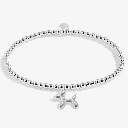 A silver beaded bracelet with a small balloon dog charm, displayed on a clean white background.
