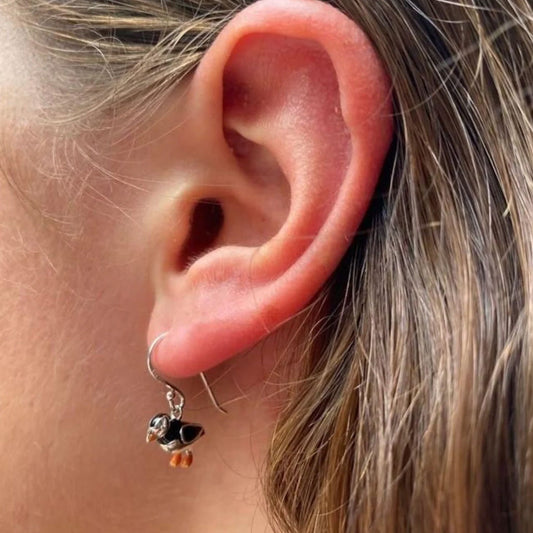 puffin earrings being worn by a lady