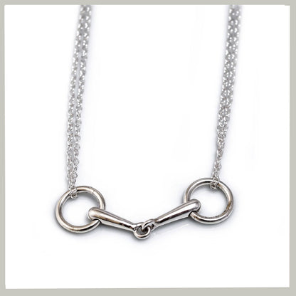 A silver horsebit necklace with a polished metal bit and chain, displayed against a clean white background.