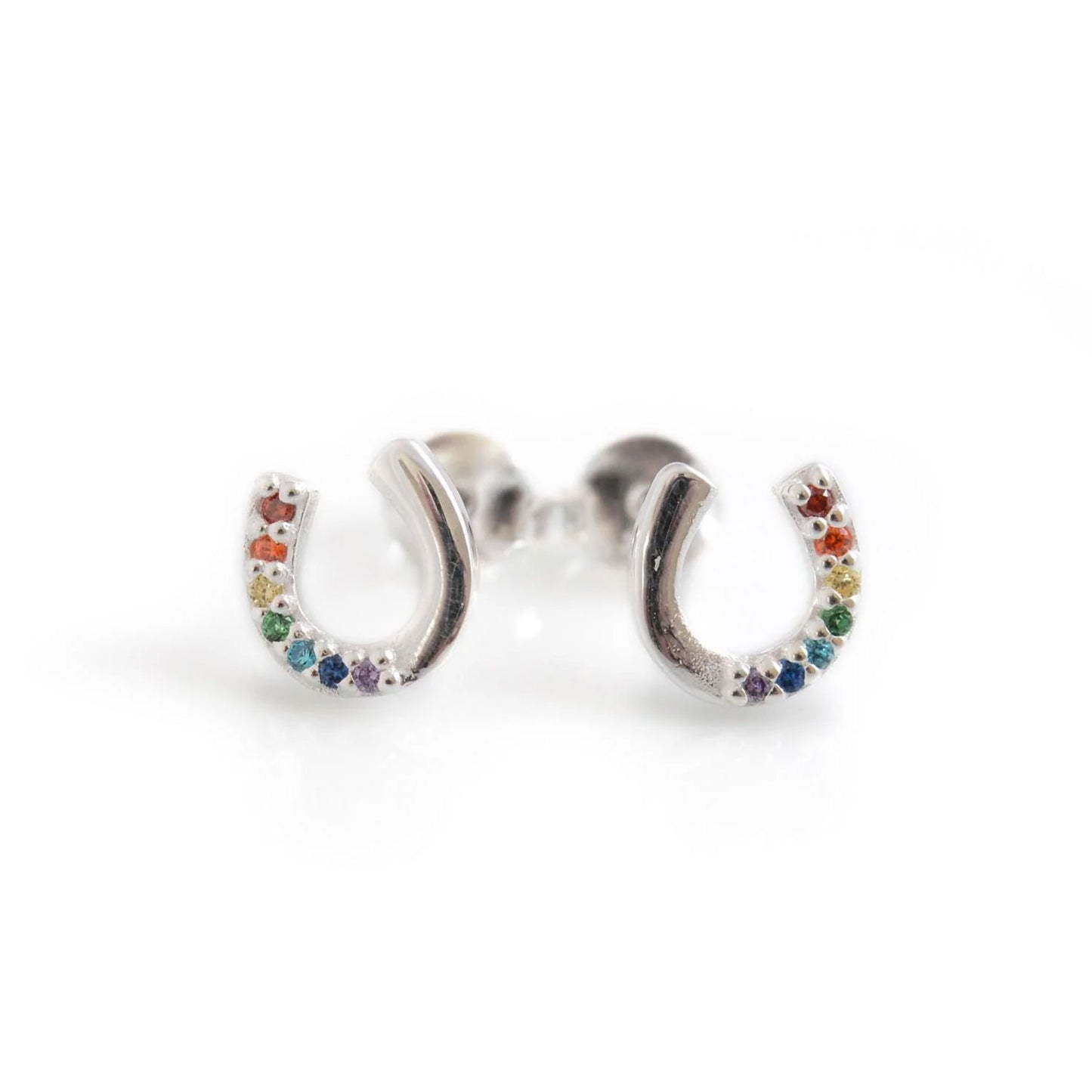 Silver earrings shaped like horseshoes with colorful stones on a white background