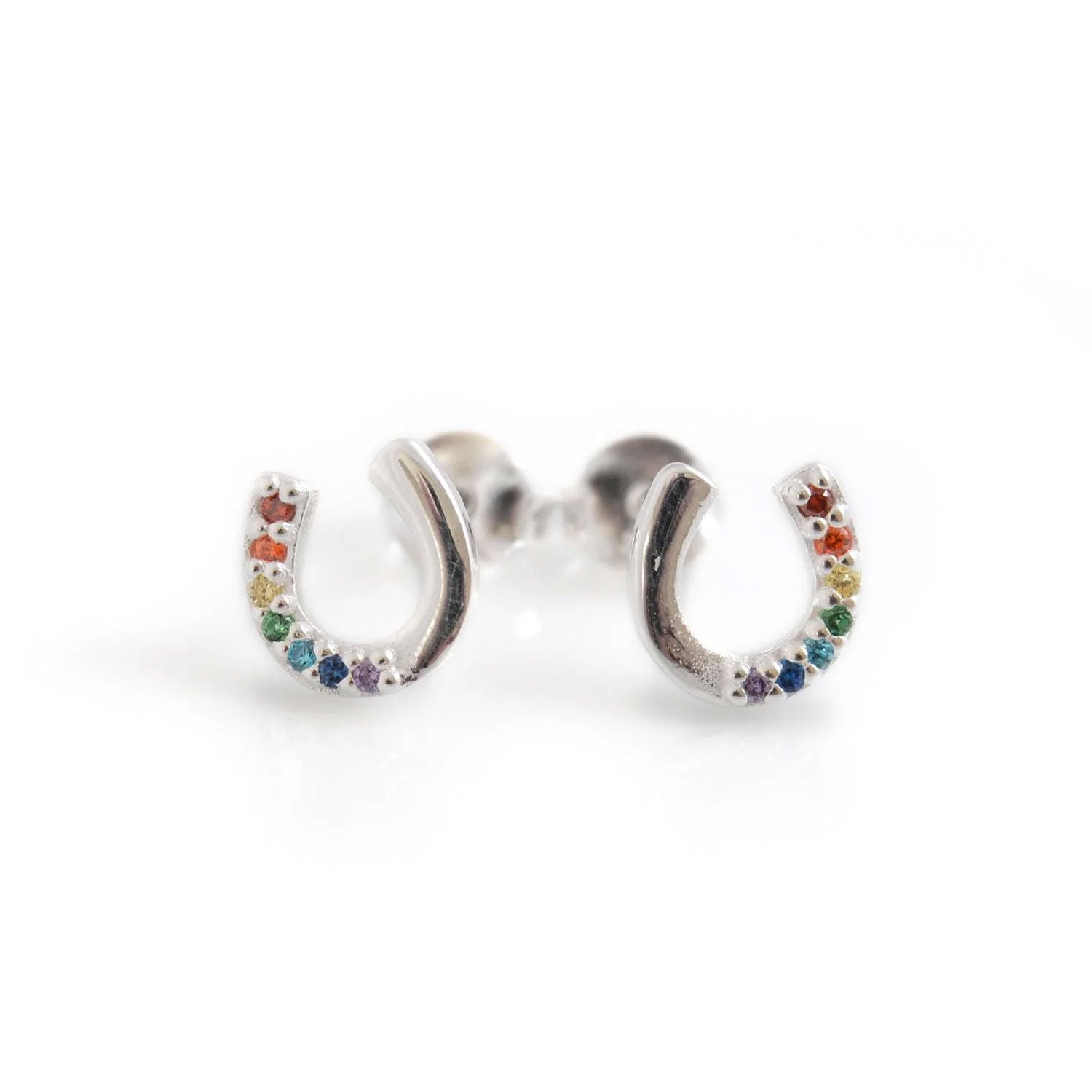 Silver earrings shaped like horseshoes with colorful stones on a white background