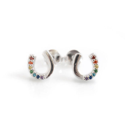 Silver earrings shaped like horseshoes with colorful stones on a white background