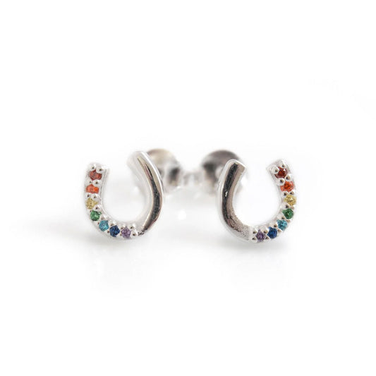 Silver earrings shaped like horseshoes with colorful stones on a white background