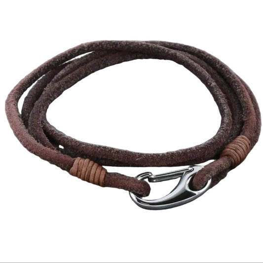 Brown leather bracelet with silver clasp on a white pouch