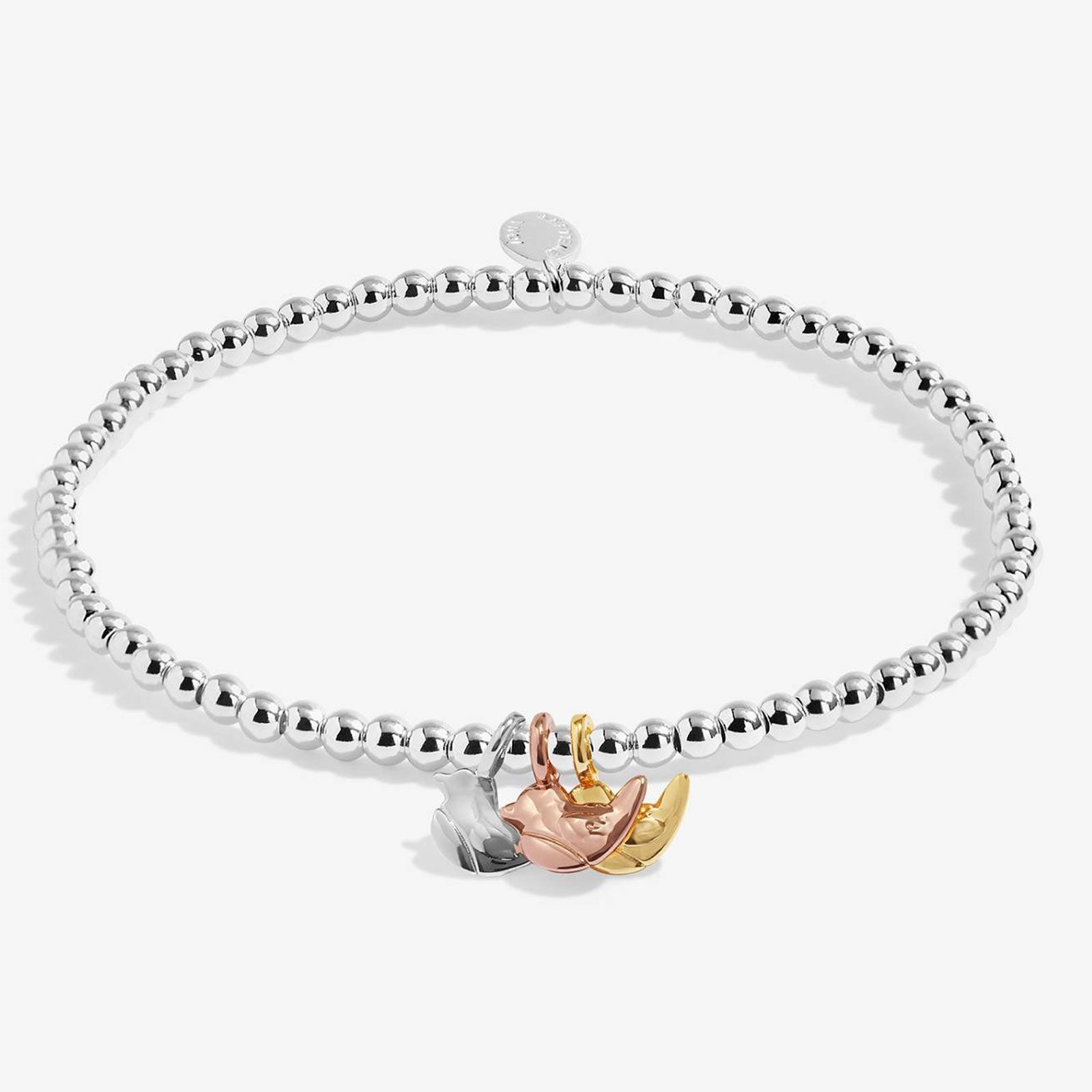 A silver beaded stretch bracelet with a three-tone charm featuring a rose gold flower, a yellow gold crescent moon, and a silver leaf, displayed on a clean white background.