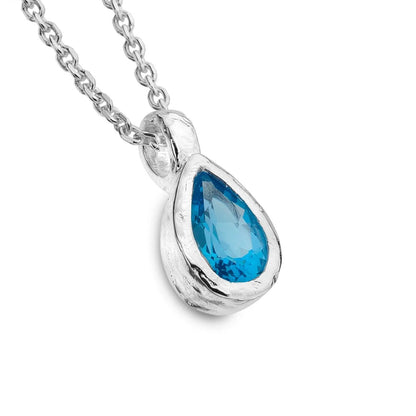 A silver and blue topaz pendant necklace, shown on a clean white background.