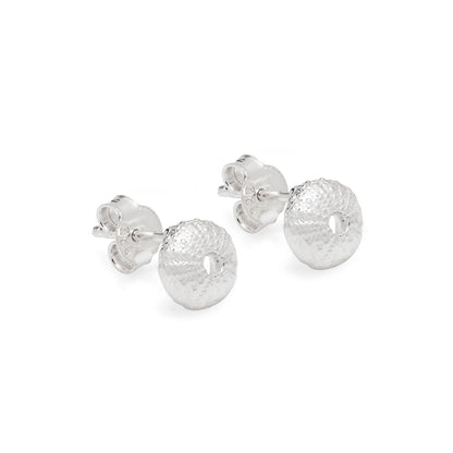 A pair of silver sea urchin stud earrings with textured, hammered circular dangles, shown on a clean white background.
