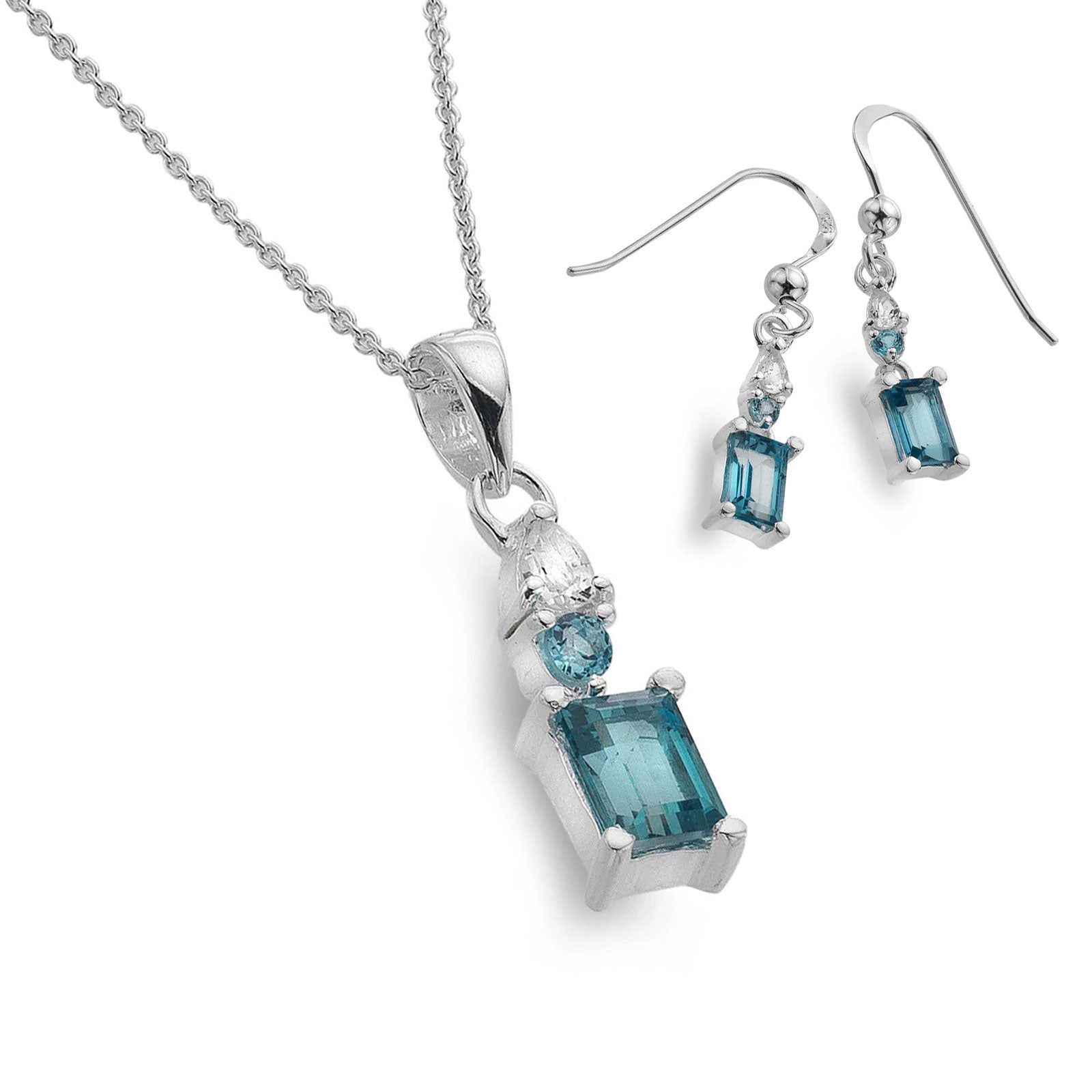 Jewelry set with pendant and earrings featuring blue gemstones on a white background