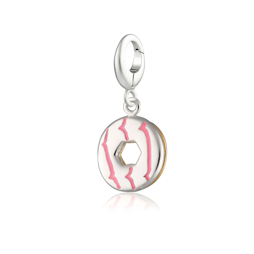 Silver and gold charm with pink design on a white background