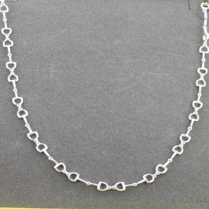 snaffle chain necklace on grey background

