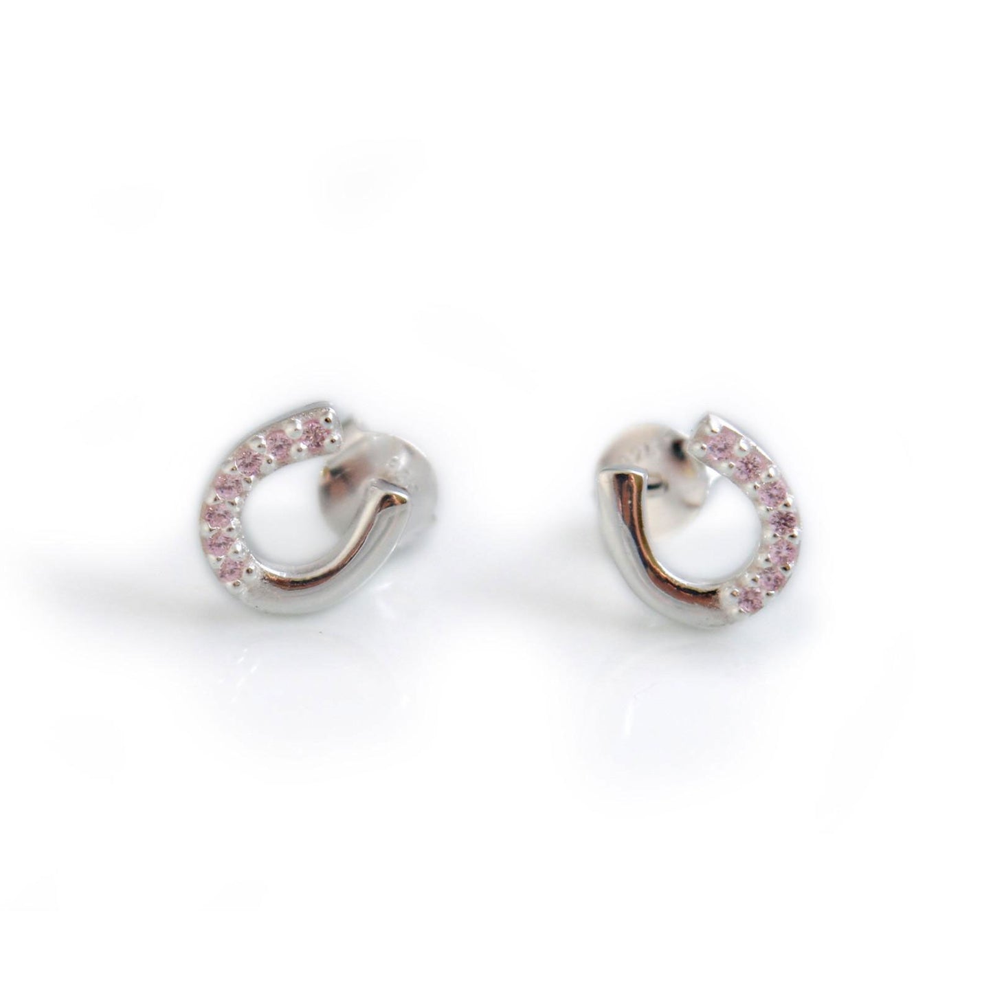 Pair of silver hoop earrings with pink stones on a white background