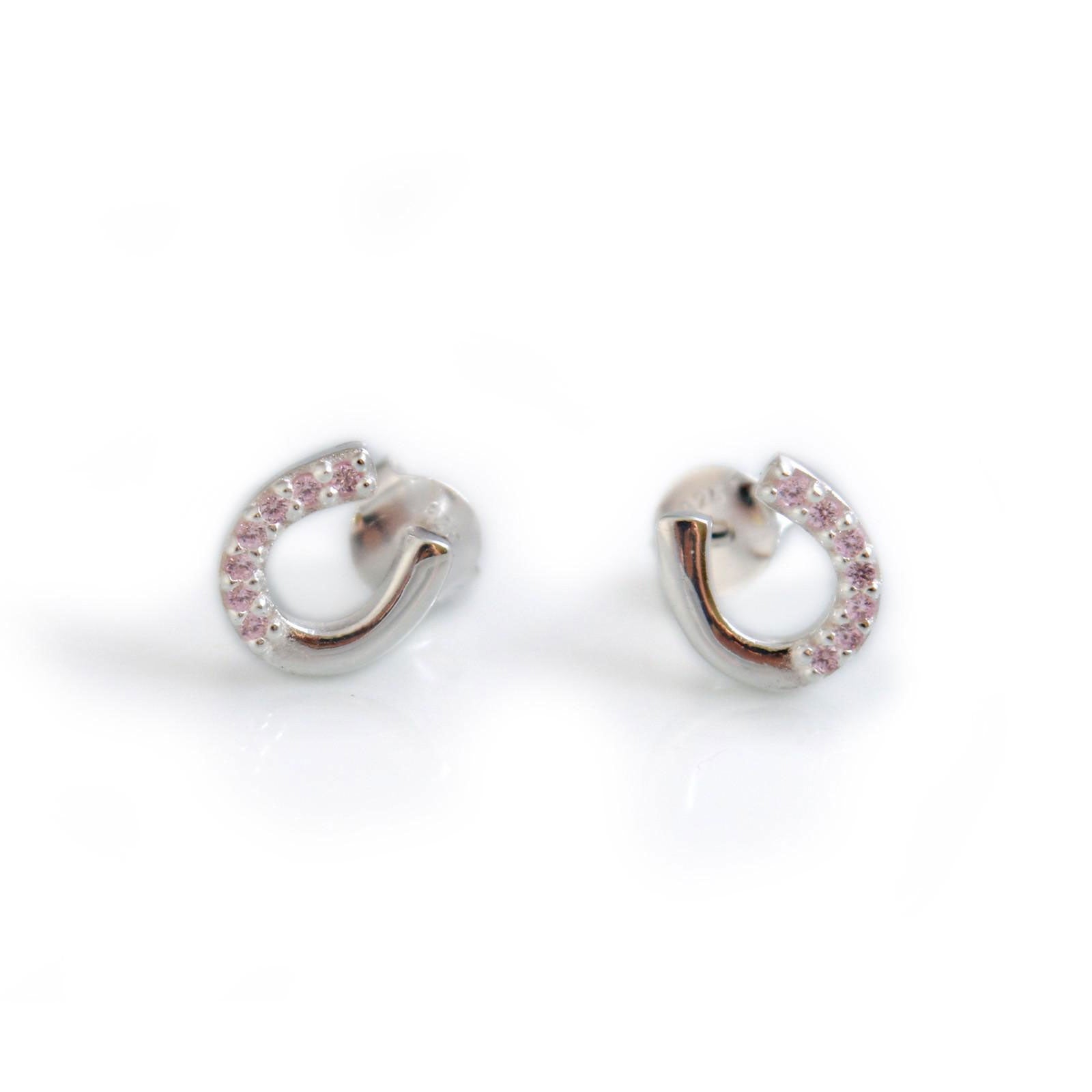 Pair of silver hoop earrings with pink stones on a white background