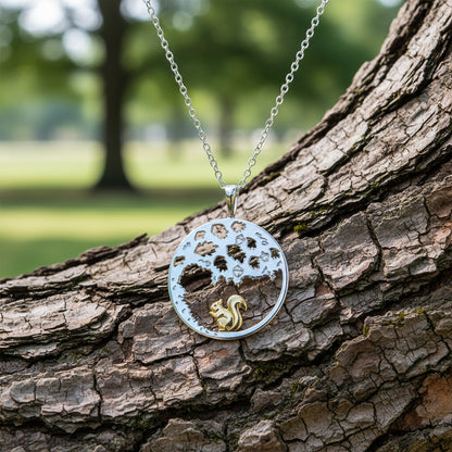 Silver necklace with a round pendant featuring a gold squirrel on a white background