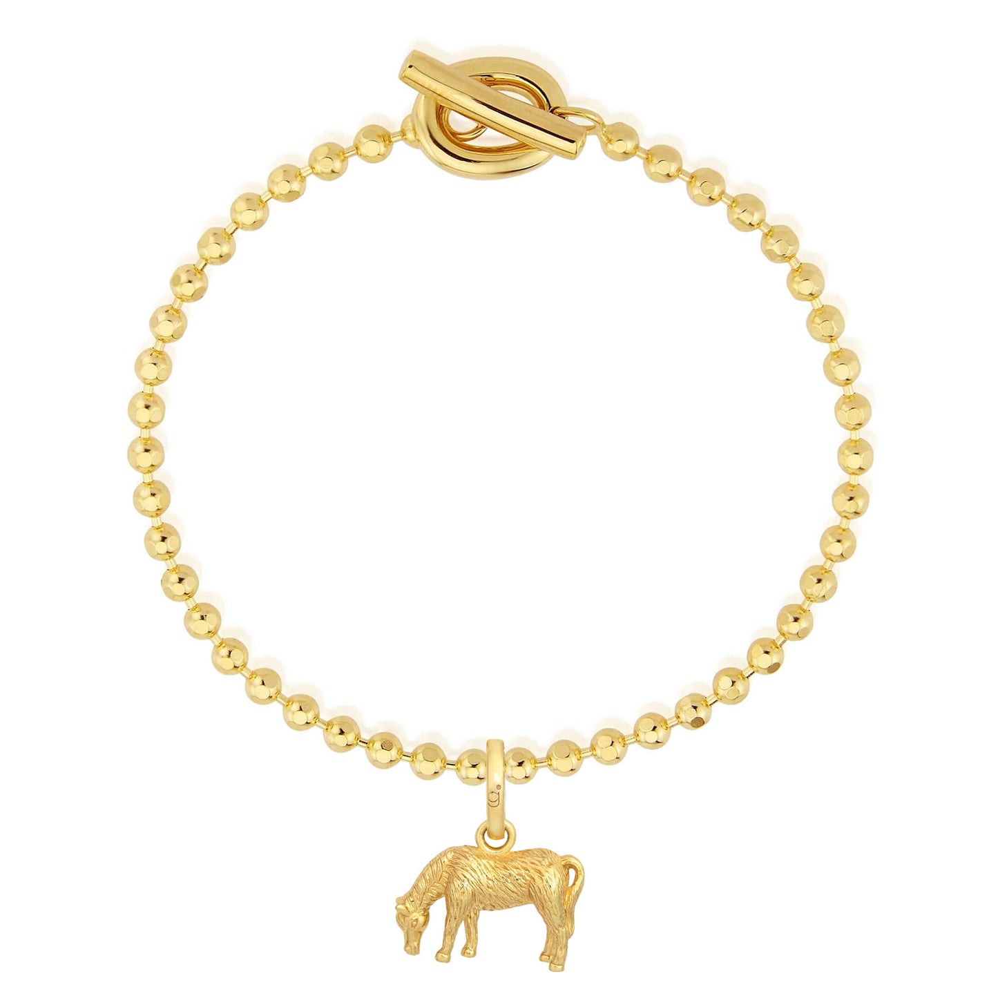 Gold bracelet with a cow charm on a white background