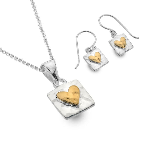 Jewelry set with heart-shaped pendant and earrings on a white background