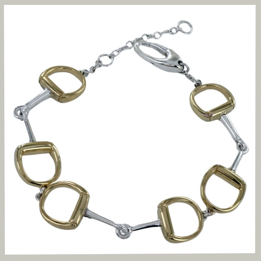 A horse-bit style bracelet featuring alternating gold and silver-toned horsebit links connected by a silver-toned chain with a lobster clasp, shown on a plain white background.