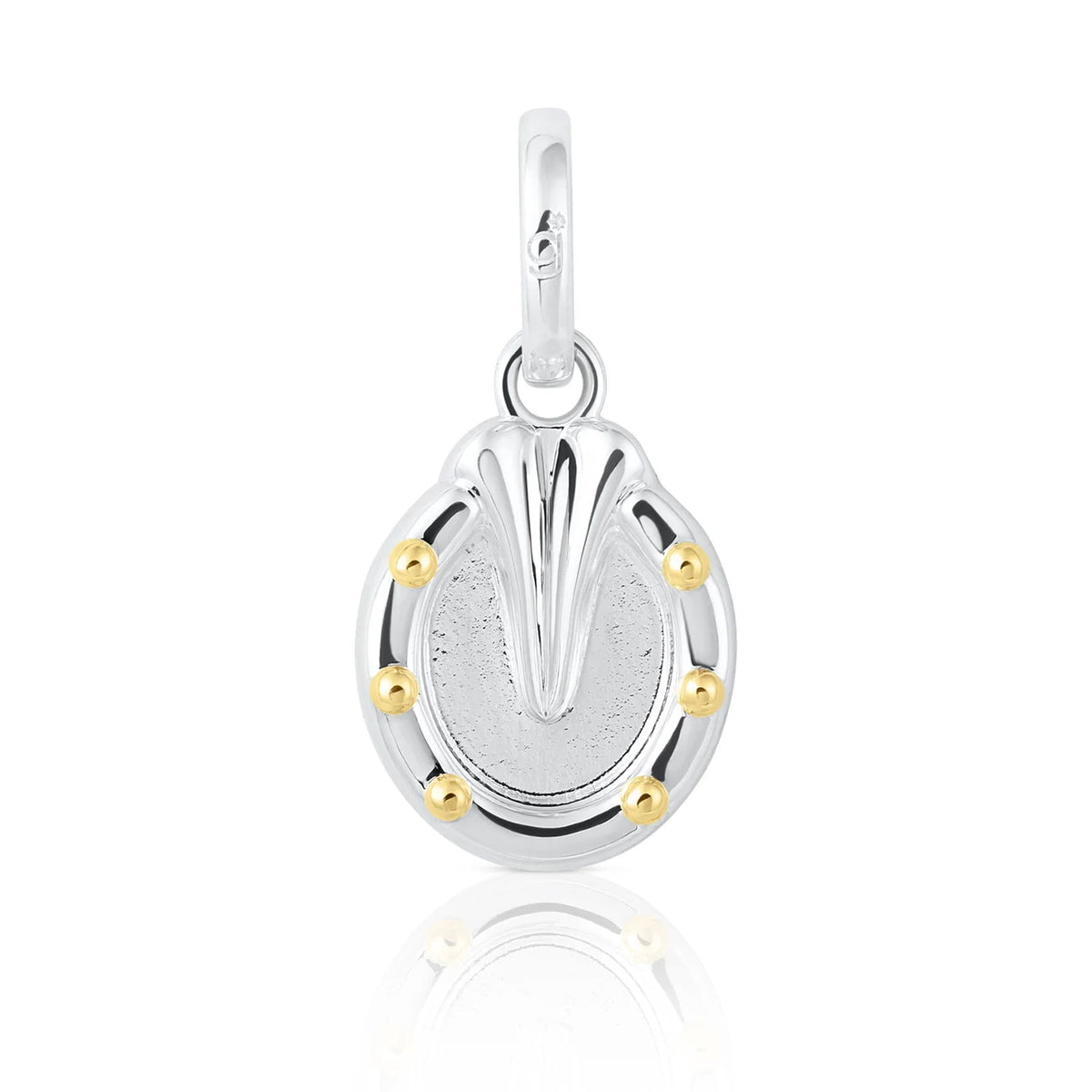 A sterling silver horseshoe charm pendant with a textured center, polished top, and five small gold bezel-set accents around the perimeter, shown on a white background with a soft reflection.