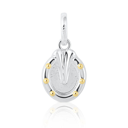 A sterling silver horseshoe charm pendant with a textured center, polished top, and five small gold bezel-set accents around the perimeter, shown on a white background with a soft reflection.