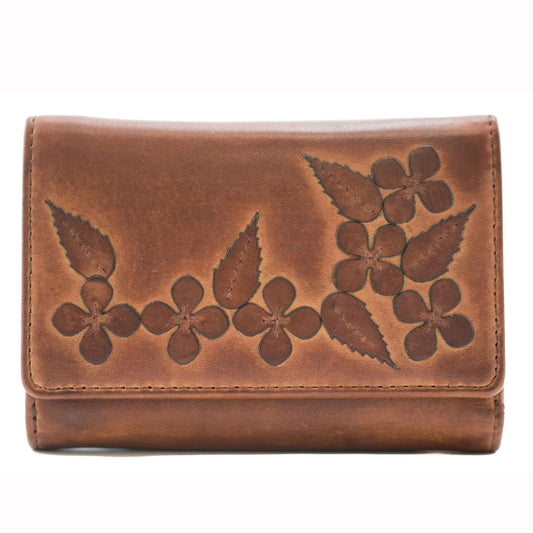Brown leather wallet with floral embossing on a white background